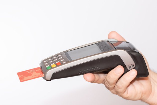 person-holding-payment-terminal-with-red-credit-card-swiped-through-machine_181624-20713.jpg